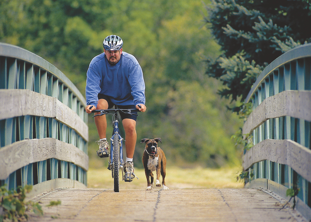 man riding bike across river