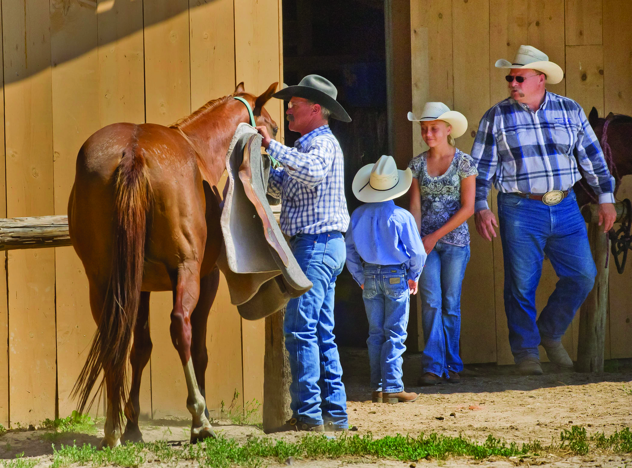 A person get a horse ready for a ride at Rowse's 1+1 Ranch in Burwell, NE.Ranch
