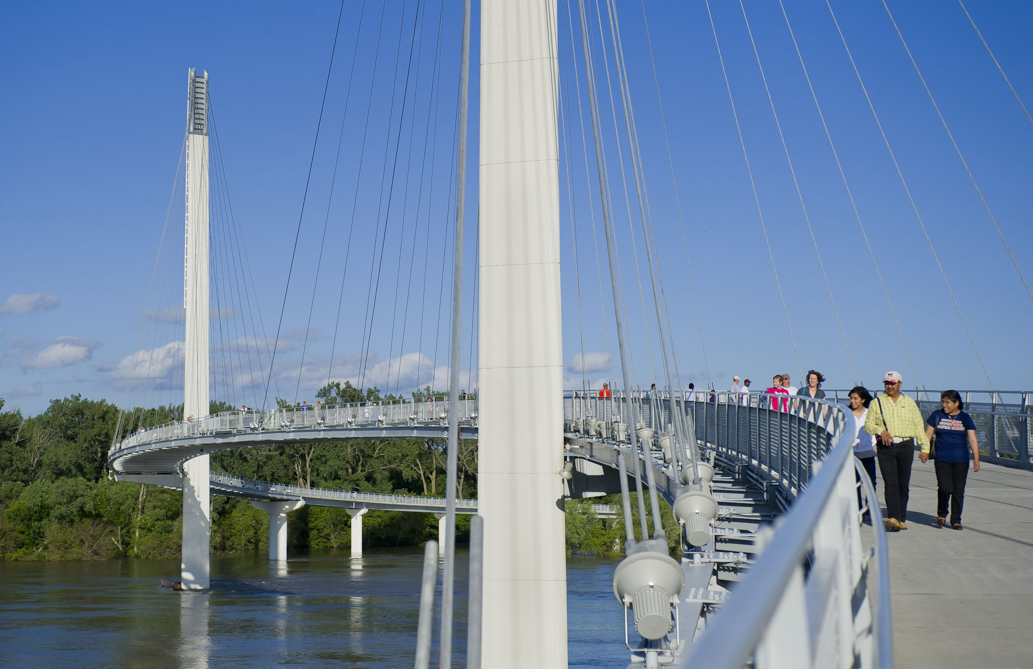 People trekking across the Bob Kerrey Pedestrian Bridge over the Missouri River from Omaha to Iowa.