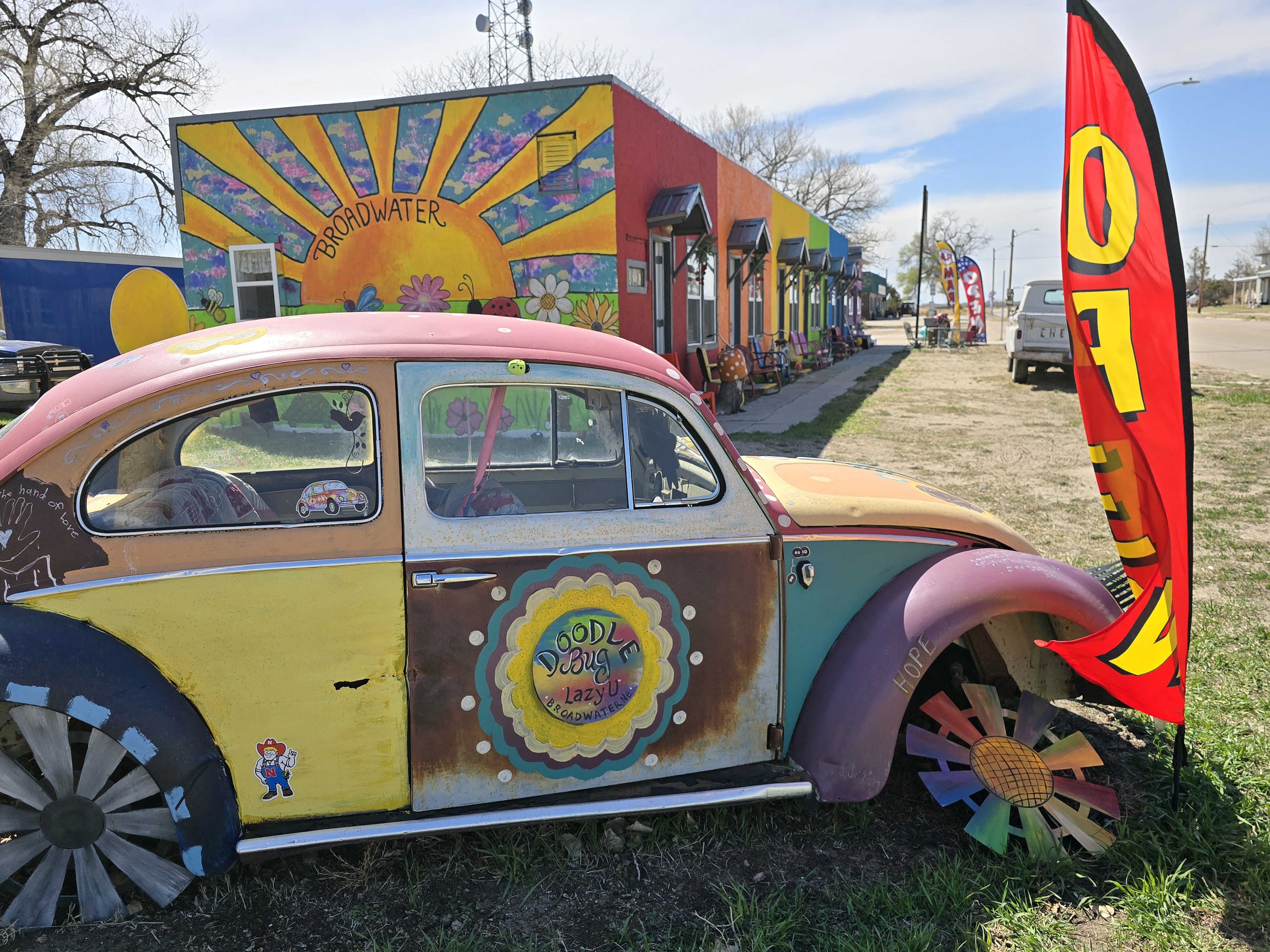 Classic car and colorful outside view of Lazy U Roadside Market.