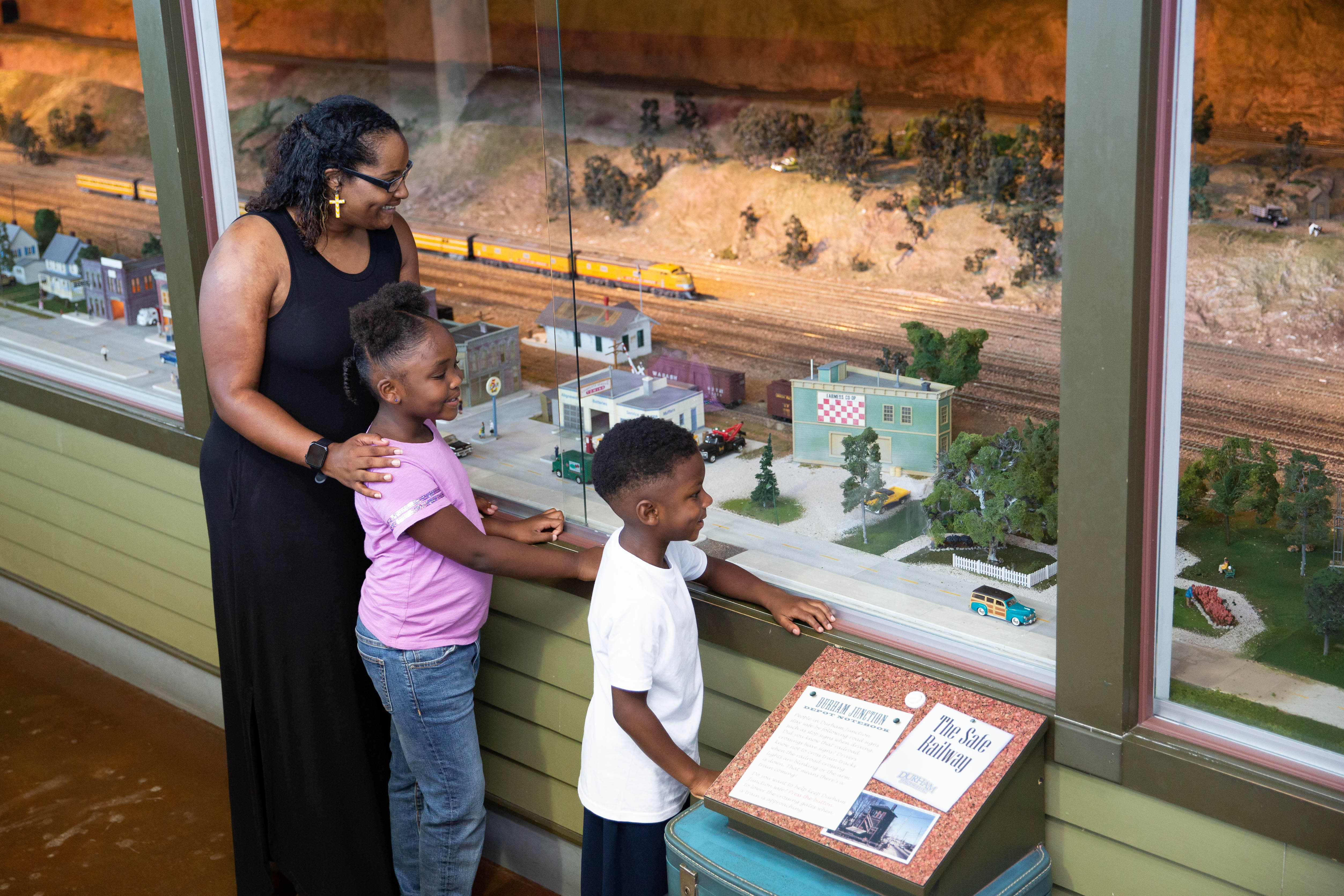 Mother and two children look at the model display casing at The Durham Museum in Omaha