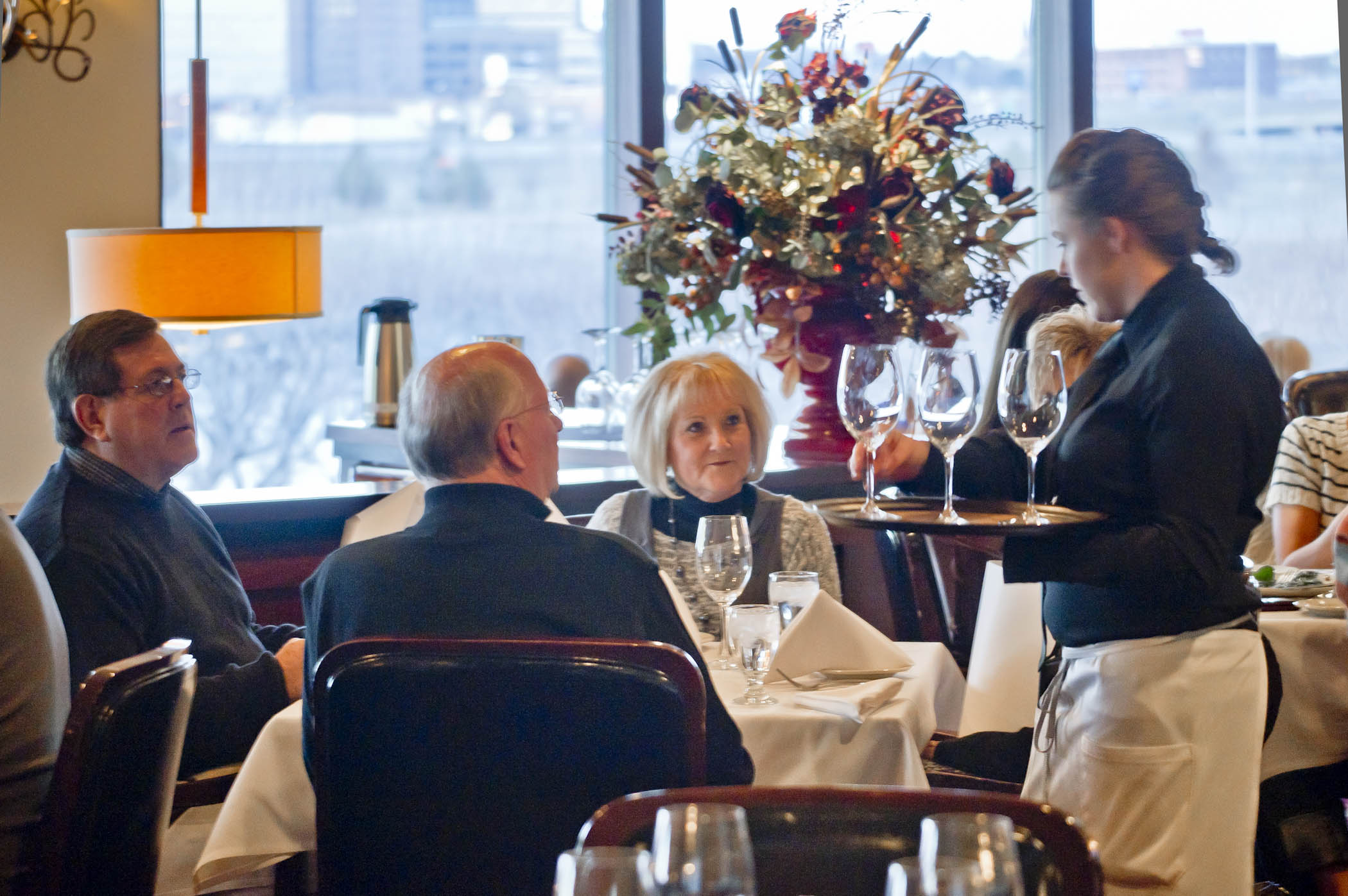 Guests receiving their drink orders from a waiter at Kahill's Chophouse in South Sioux City.