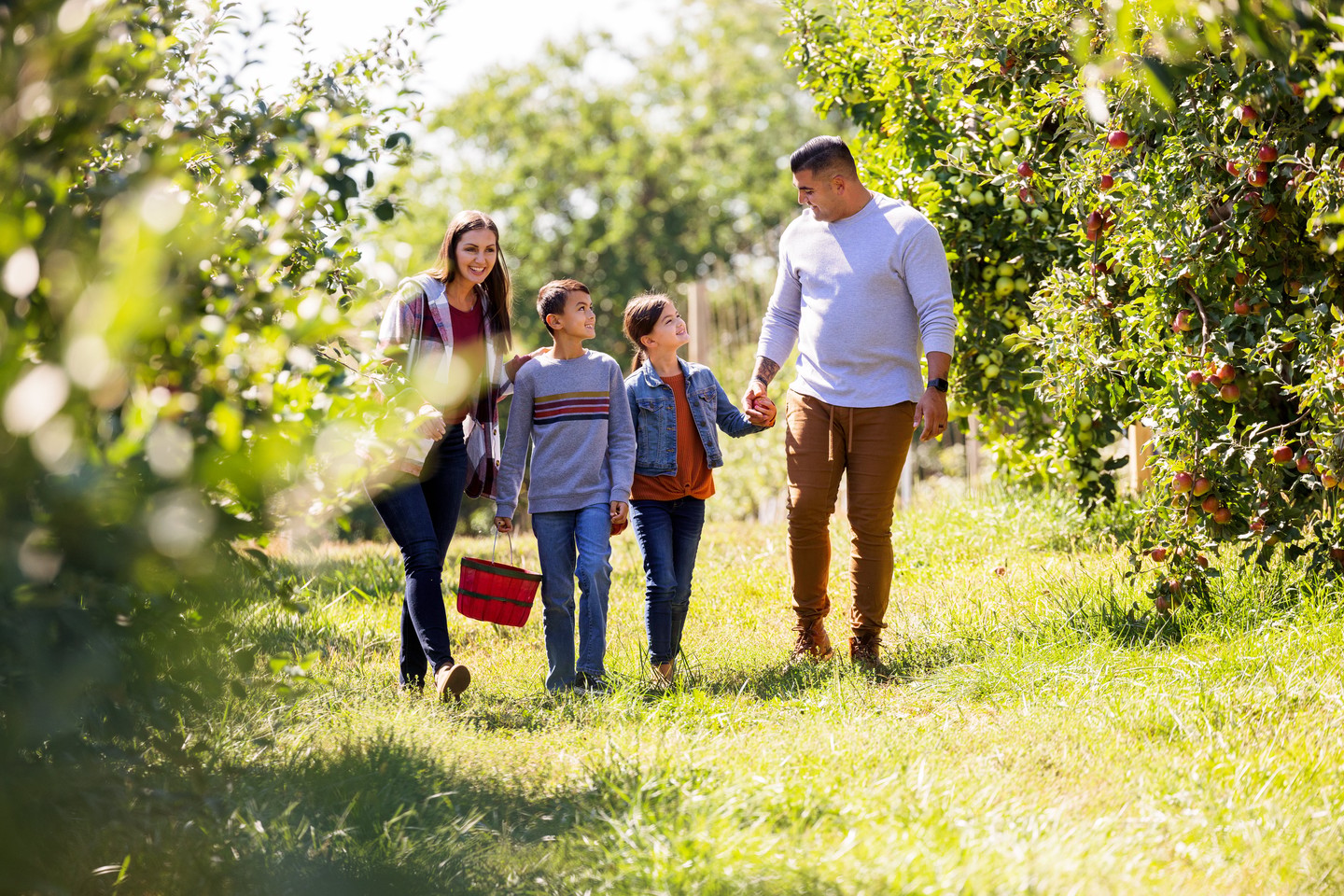 Family picking fruit in spring for Arbor Day in Nebraska.