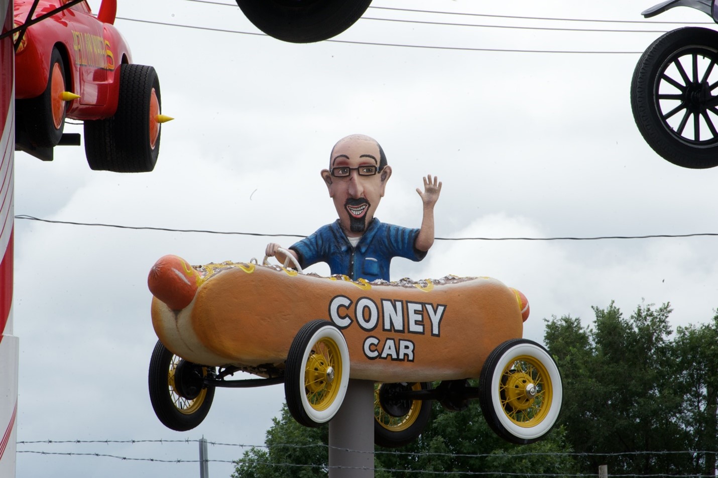 The Coney Car  cartoon car with a replica of George driving it, suspended in the air at Fred's Flying Circus.