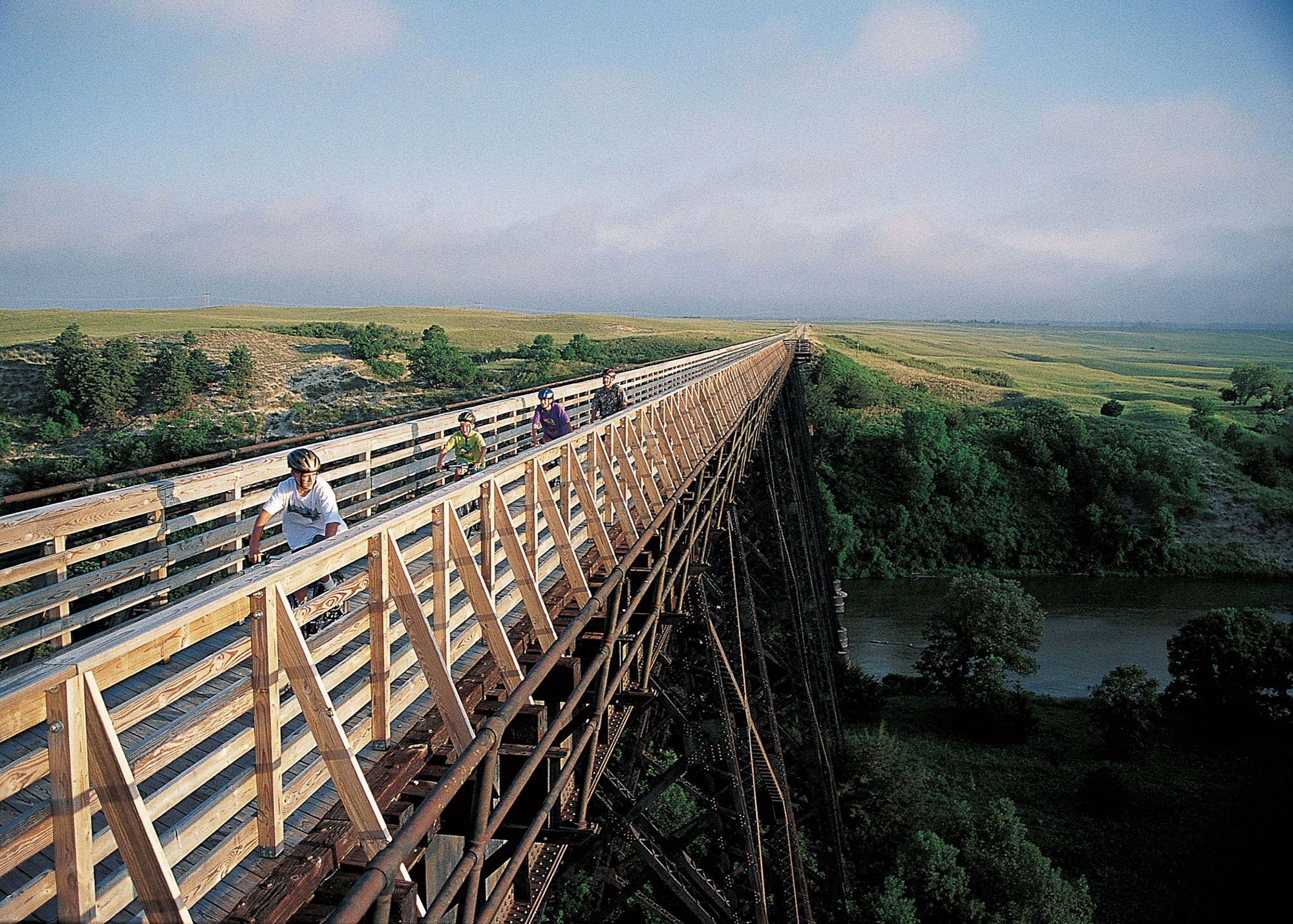 Bikers on a bridge along The Cowboy Trail.