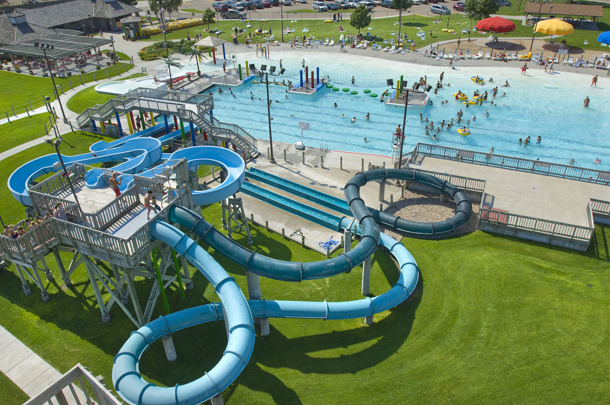 Atop a waterslide platform, excited guests wait their turn to slip down the water tunnels at Island Oasis Water Park in Grand Island, NE.