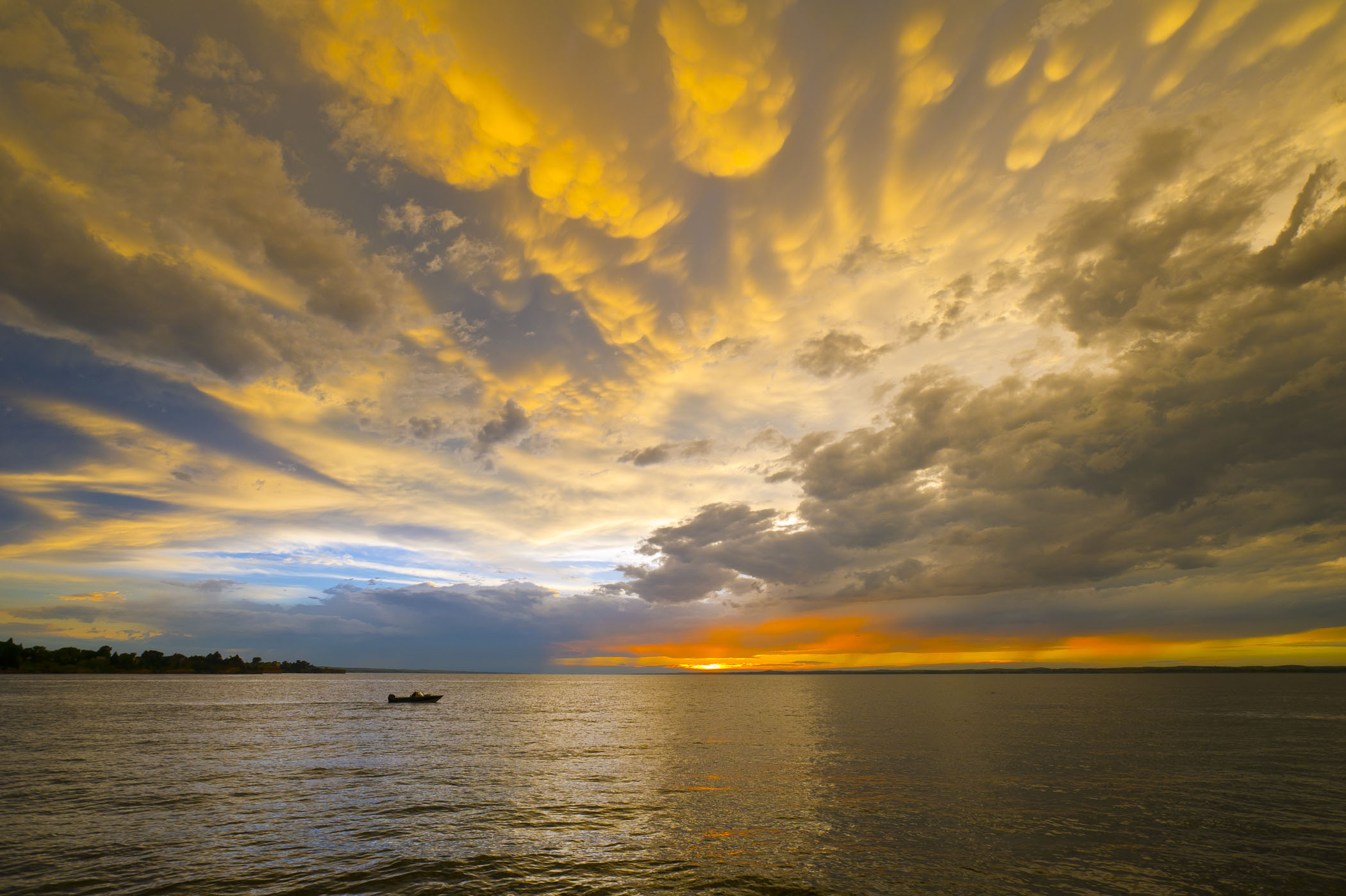 A boat on the water at sunset at Lake McConaughy in Ogallala