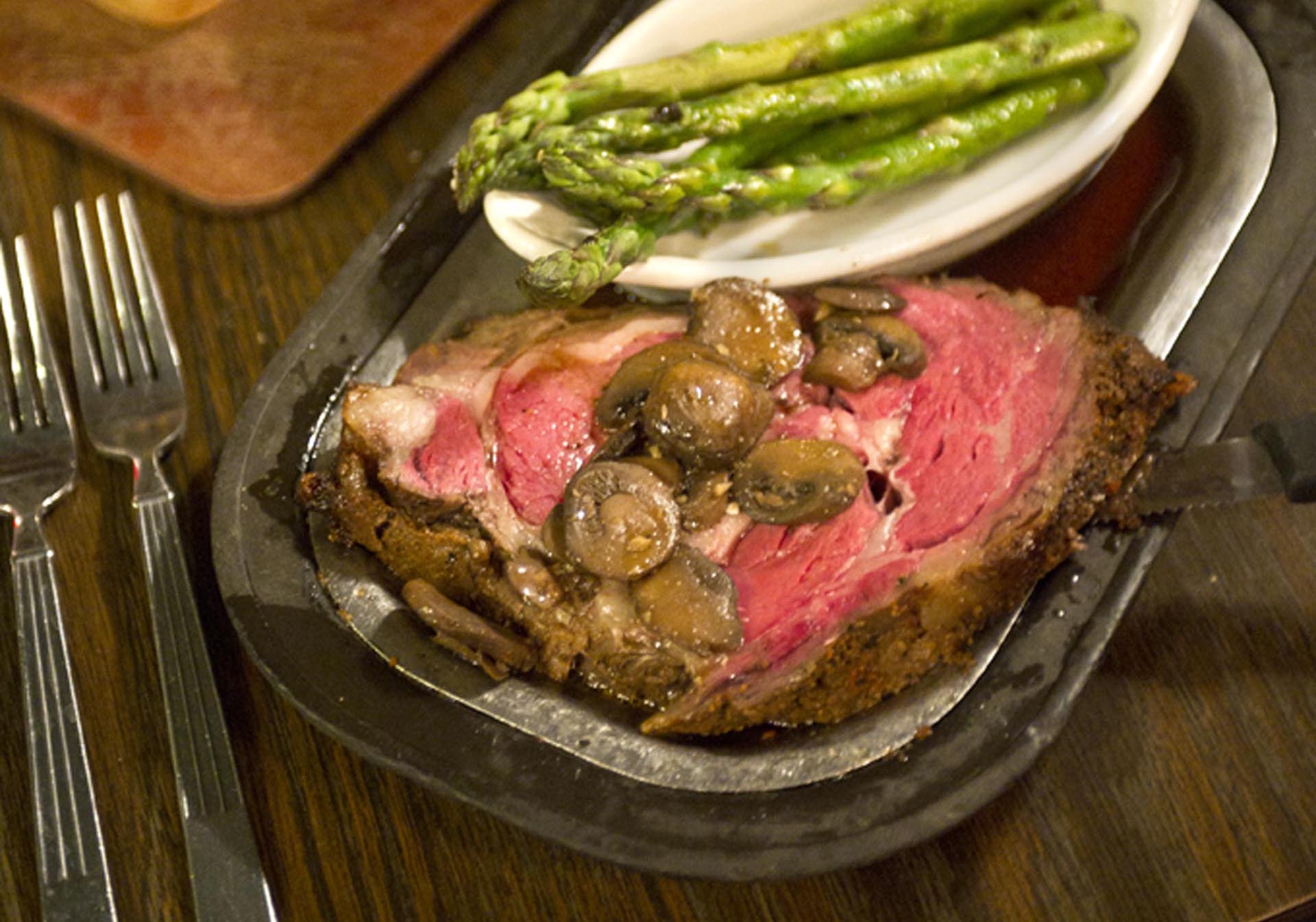 A plate of prime rib and asparagus at Misty's Steakhouse.