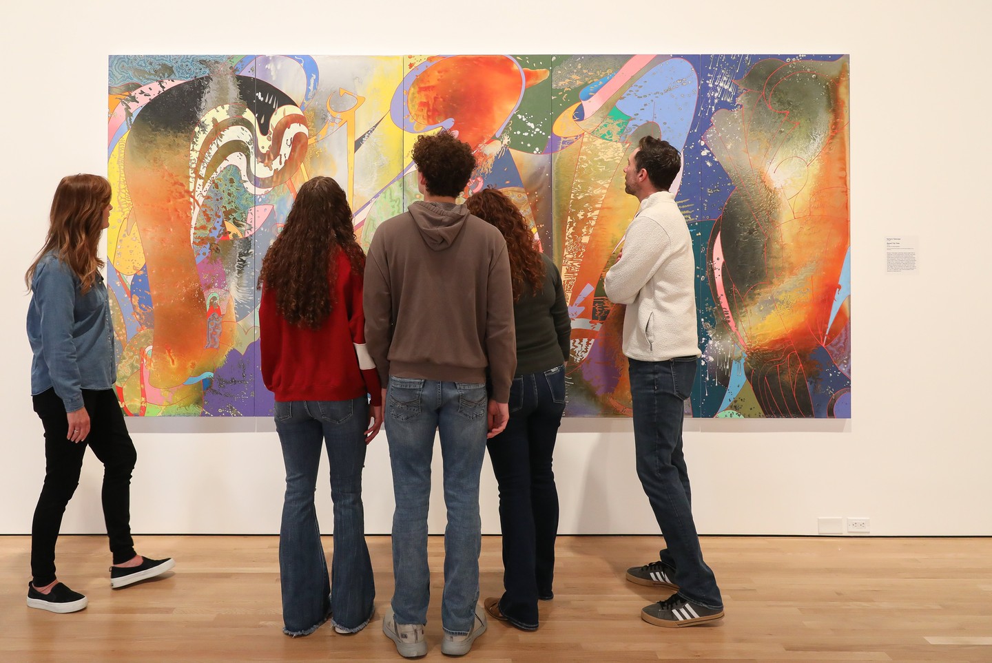 Five guests looking at a painting at Museum of Nebraska Art.