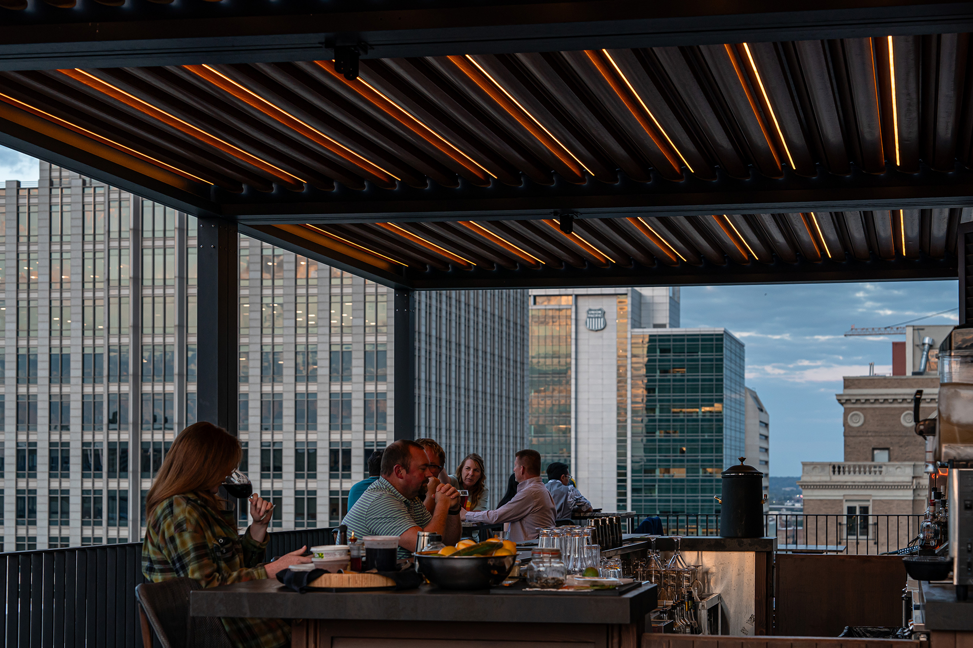 People eating at the rooftop bar at The Peregrine Hotel.