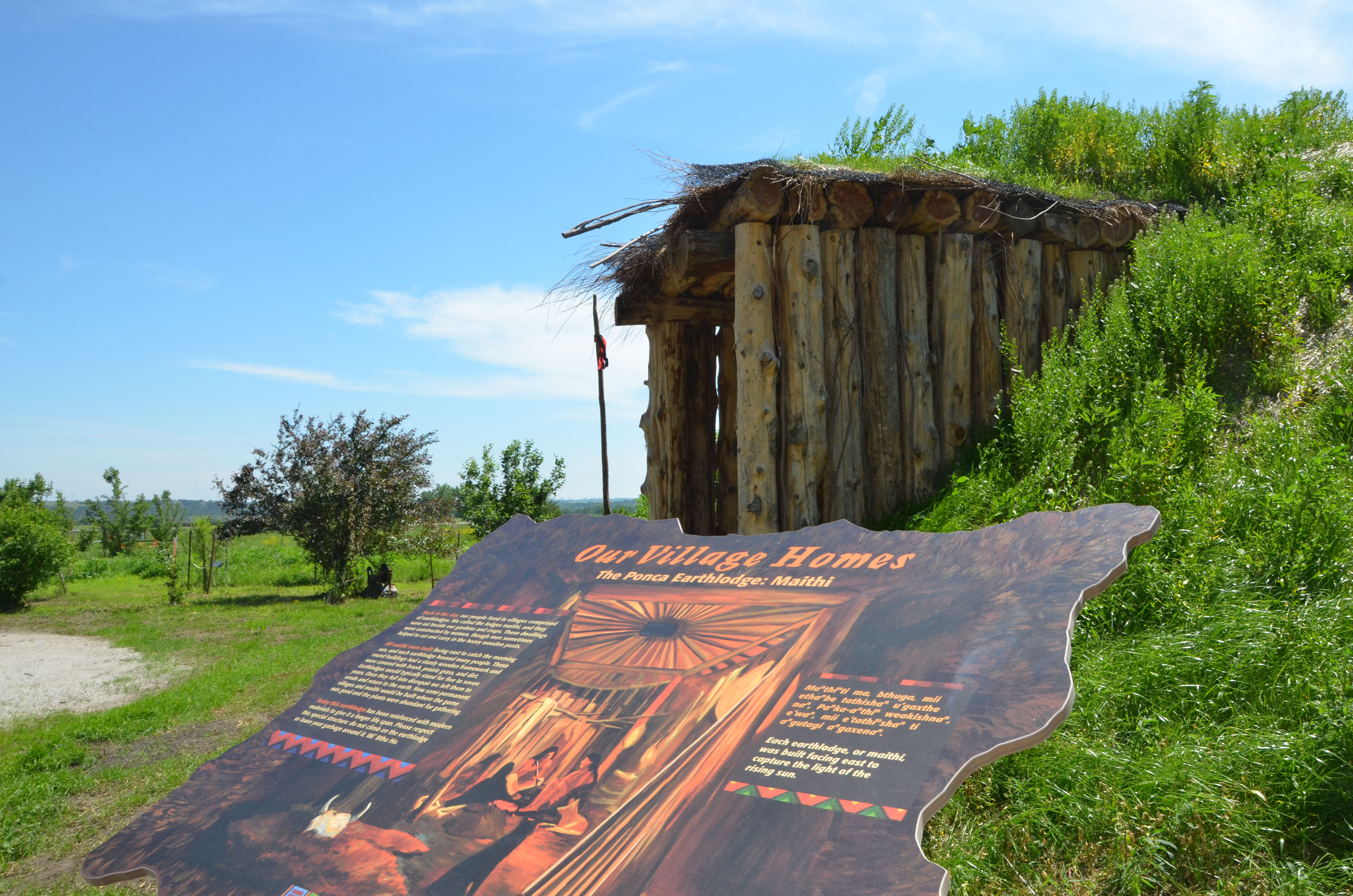 Sign and structure on the Ponca Educational Trail and Earthlodge.