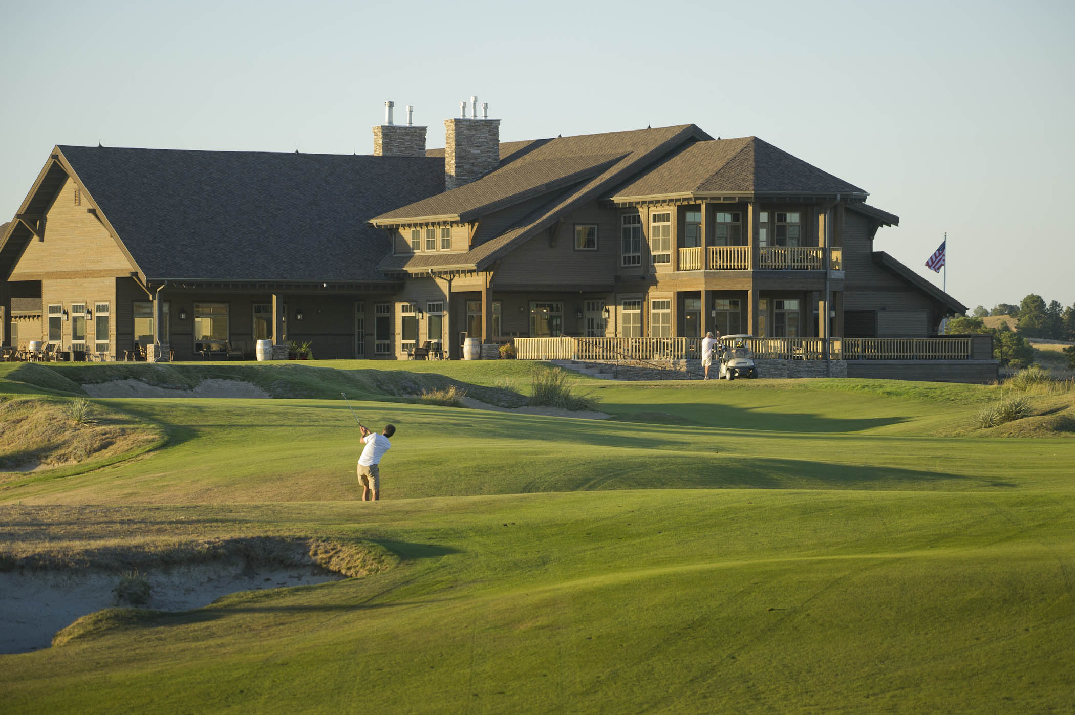 A golfer on the course outside the clubhouse at The Prairie Club.