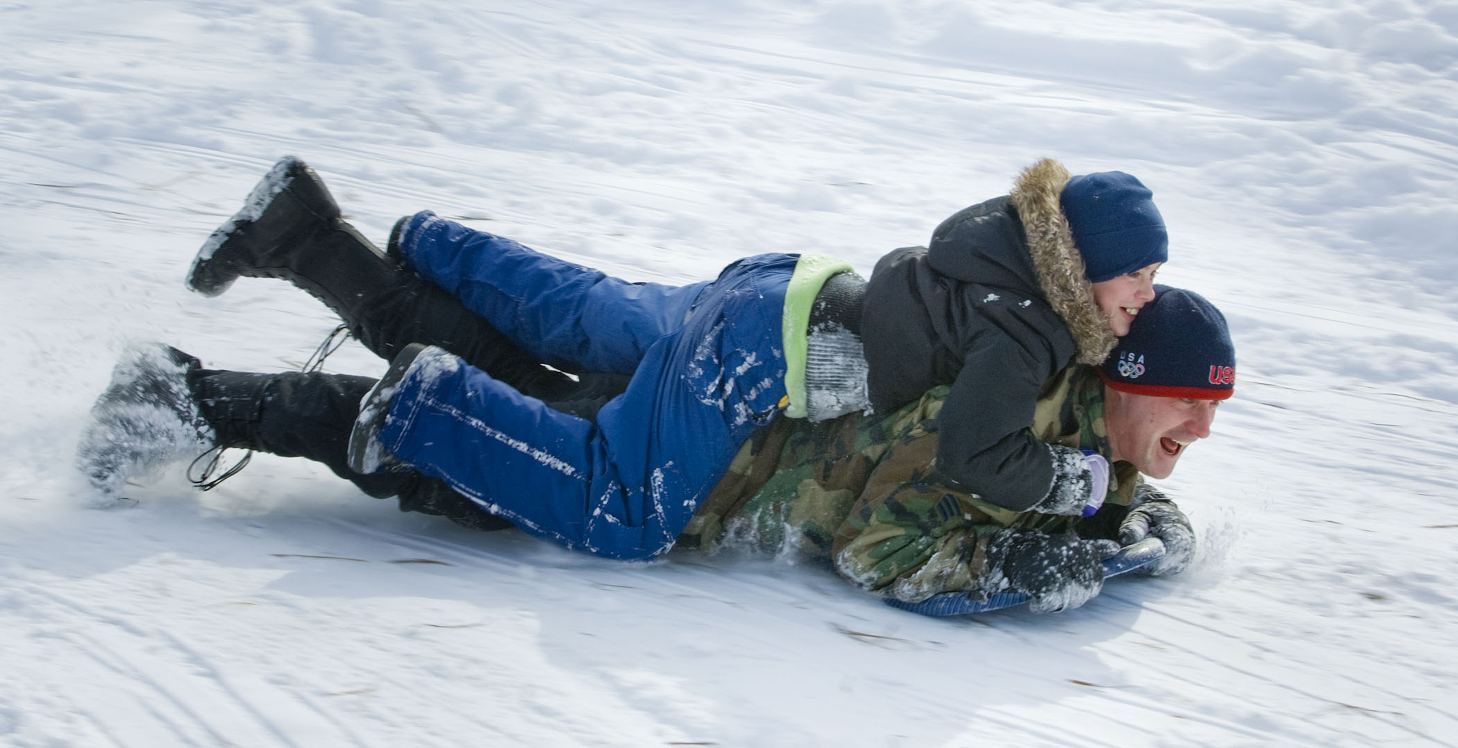 A father and son sled together in Mahoney State Park in Ashland, Nebraska