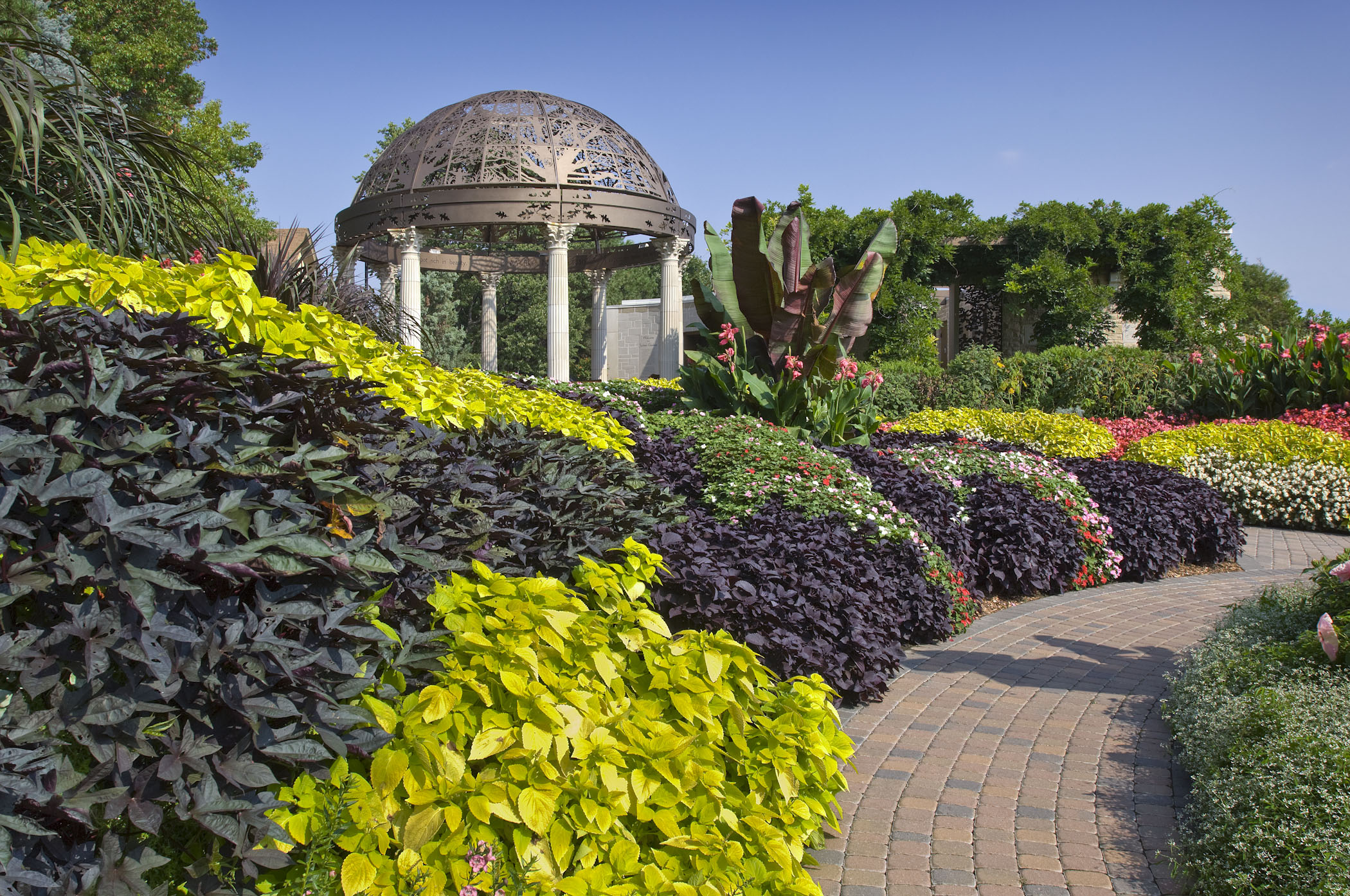 Colorful plant life and a decorative gazebo at Sunken Gardens.