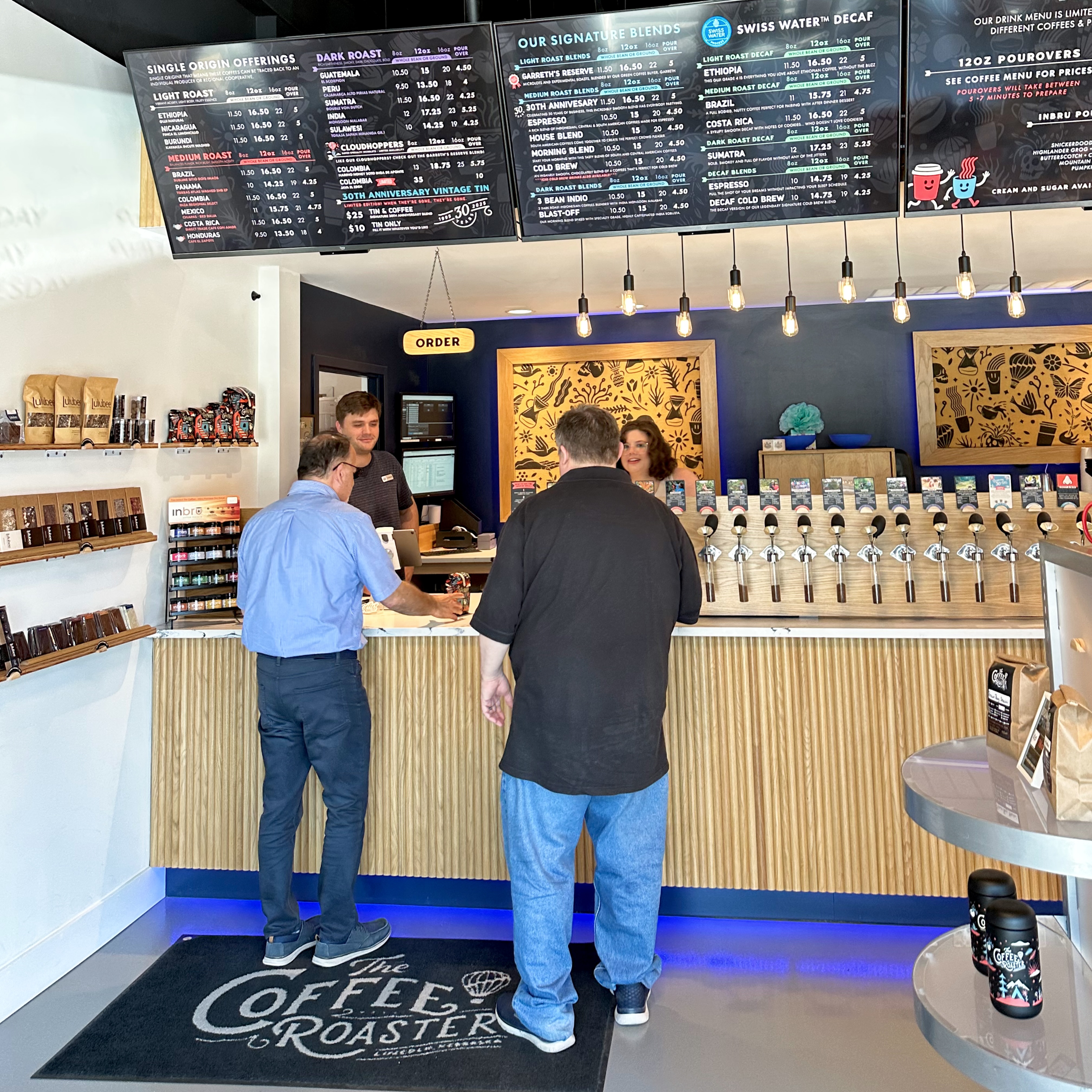Customers ordering at the counter at The Coffee Roaster.