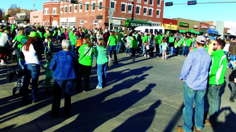 A crowd dressed in green for the painting of the world's largest shamrock in O'Neill, Nebraska, as part of the town's St. Patrick's Day celebrations.